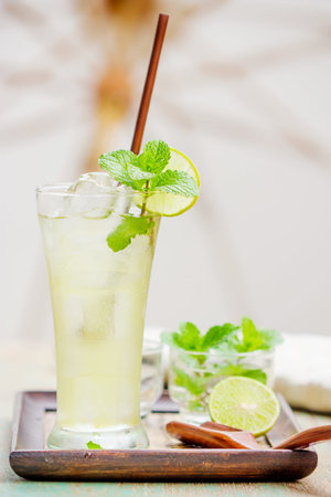 Iced green tea with lime garnish and ice cube