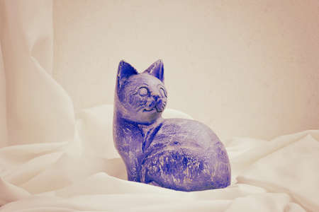 A handmade wooden sculpture of cat painted by hand  Still life の写真素材