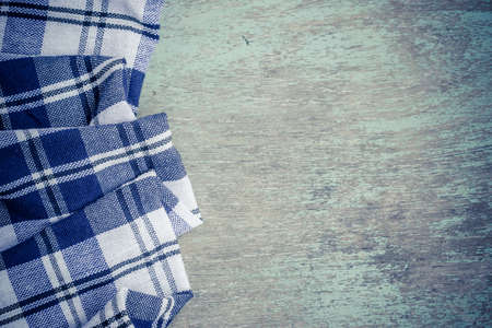 the background made from checkered napkin on wooden tableの写真素材