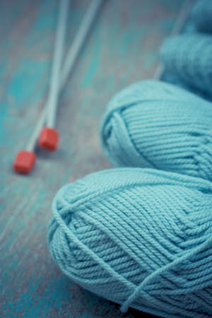 Ball of yarn and knitting on a wooden tableの写真素材