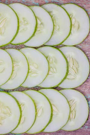 Sliced cucumber on a  wooden backgroundの写真素材
