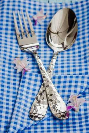 Silverware at napkin on wooden backgroundの写真素材
