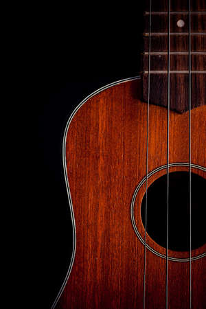 Ukulele hawaiian guitar over dark background の写真素材