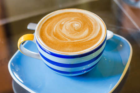 Blue and white cup of latte coffee Blue and white cup of latte coffee