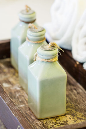 Hotel amenities kit in basket on woodenの写真素材