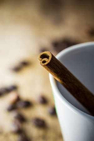 Sugar Stick Cinnamon in white cup coffeeの写真素材