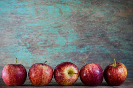 Ripe red apples on wooden backgroundの写真素材