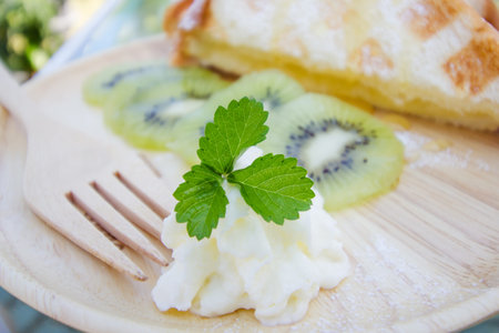 Kiwi waffle with honey  on wooden plate