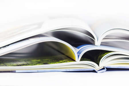 a pile of magazines close up on white backgroundの写真素材