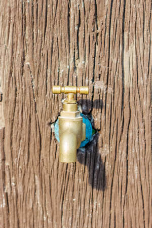 faucet on stone wall in gardenの写真素材
