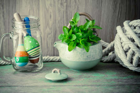 Fresh mint in tea pot on  wooden backgroundの写真素材