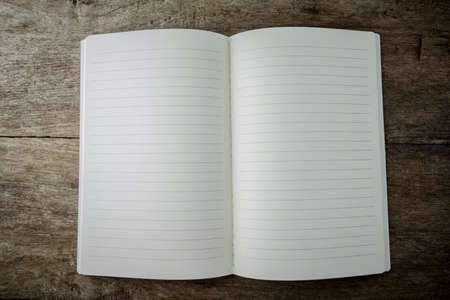 open blank lined notebook on wooden backgroundの写真素材