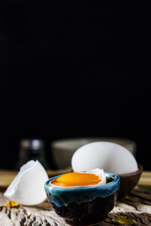 Still life broken white eggs and egg yolk on a wooden rustic background