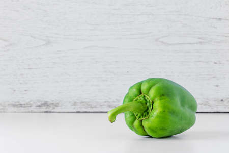 Green bell pepper on the wooden backgroundの写真素材