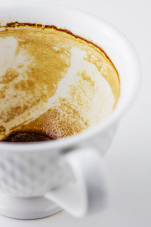 Empty coffee cup, Dregs in the bottom of the cup.