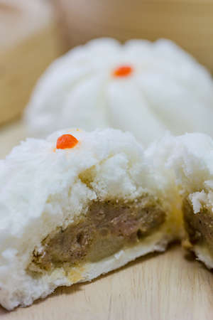 Chinese barbecued pork bun tear into two half on woodenの写真素材