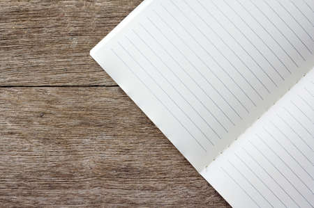 open blank lined notebook on wooden backgroundの写真素材