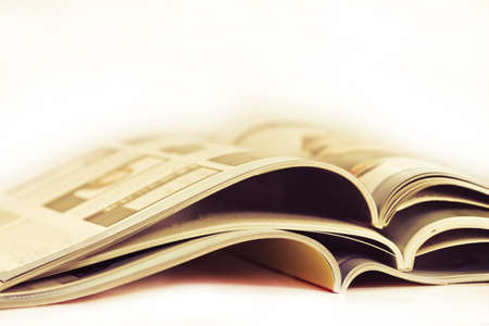 a pile of magazines close up on white backgroundの写真素材