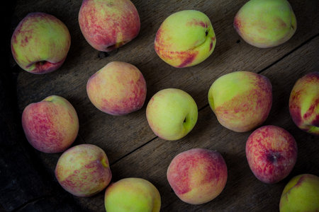 group of fresh peaches on wood background
