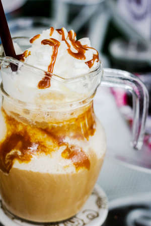 Iced caramel coffee in  glass cup on tableの写真素材