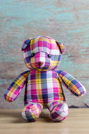 Cute teddy bear on old wooden backgroundの写真素材