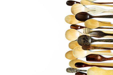Assorted different kitchen wooden utensils cutlery on a white backgroundの写真素材