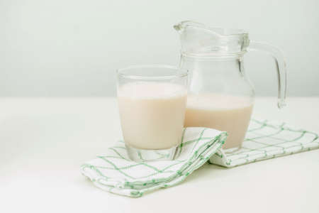 Milk in a glass jug and glassの写真素材