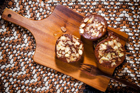 Homemade delicious fresh chocolate and almonds cake on wooden tableの写真素材