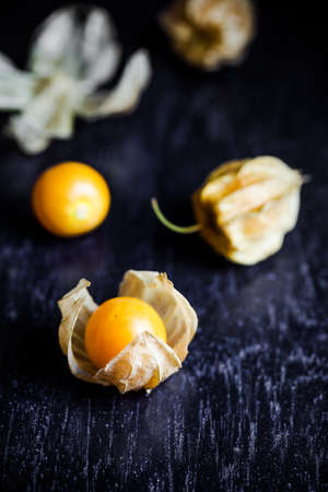 Closeup orange organic cape gooseberries on wooden backgroundの写真素材
