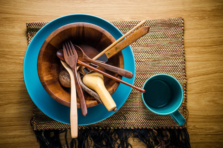 pile of wooden kitchen utensils on wooden background.