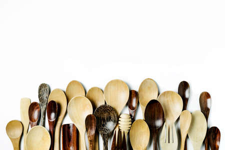 Assorted different kitchen wooden utensils cutlery on a white backgroundの写真素材