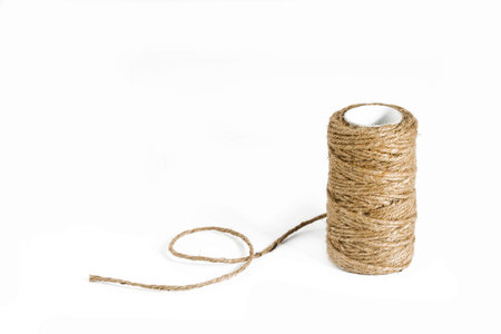A Roll of hemp rope on white background