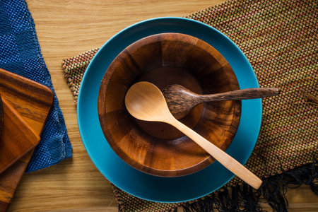 pile of wooden kitchen utensils on wooden background.