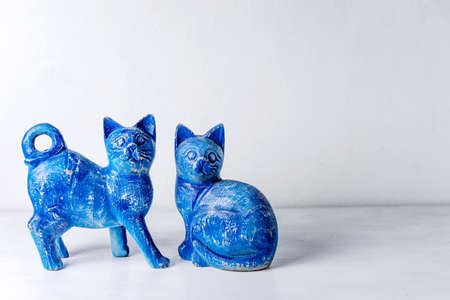 Blue wood cats on white wooden background.の写真素材
