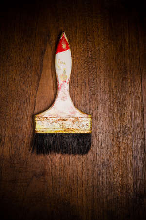 old dirty paint brush  on wooden backgroundの写真素材