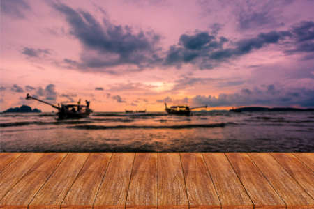 Wood table top on blurred beach background - can be used for display or montage your productsの写真素材