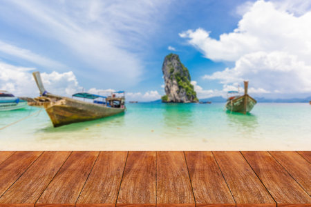 Wood table top on blurred beach background - can be used for display or montage your products