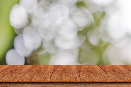 Wood table top on bokeh abstract green background - can be used for montage or display your productsの写真素材