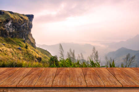 Empty wooden table with mountain landscape background for displaying your productの写真素材