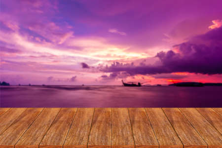 Wood table top on blurred beach background - can be used for display or montage your productsの写真素材