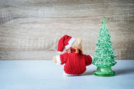 Christmas decoration Teddy Bear and christmas tree on wooden backgroundの写真素材