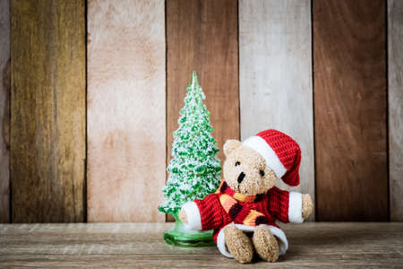 Christmas decoration Teddy Bear and christmas tree on wooden backgroundの写真素材