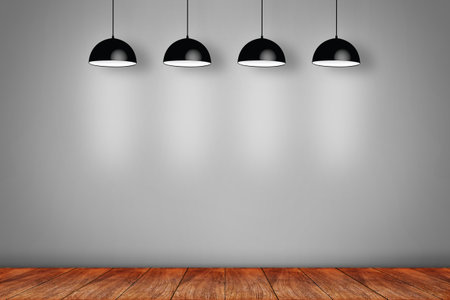 wooden laminate floor and gray wall with ceiling lamps