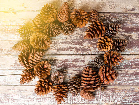 Top view of pine cones on rustic wooden backgroundの写真素材