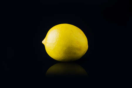 fresh lemon fruit on the black backgroundの写真素材