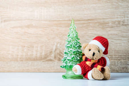 Christmas decoration Teddy Bear and christmas tree on wooden backgroundの写真素材