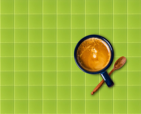 Cup of coffee on green glass backgroundの写真素材