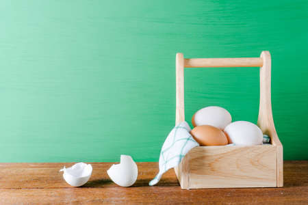 Many eggs in box on green background.の写真素材