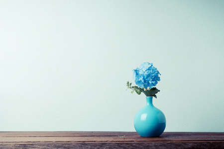Blue plumbago flowers in vase (Cape Leadwort or Plumbago auriculata) on wooden table. vintage tone.の写真素材