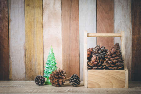 Christmas decoration  with christmas tree and pine cones on wooden backgroundの写真素材